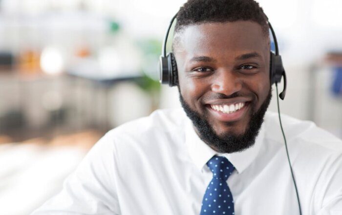 A customer service associate with a headset on implementing best practices to reduce B2B customer churn.